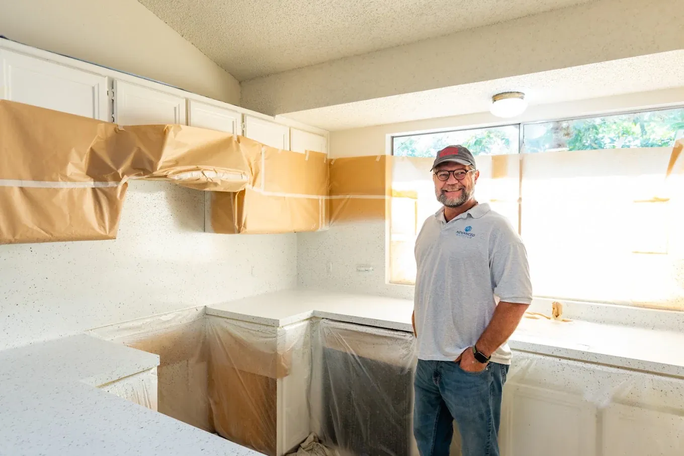 Jeff Evans, owner of Advanced Refinish, on a kitchen countertop refinishing job