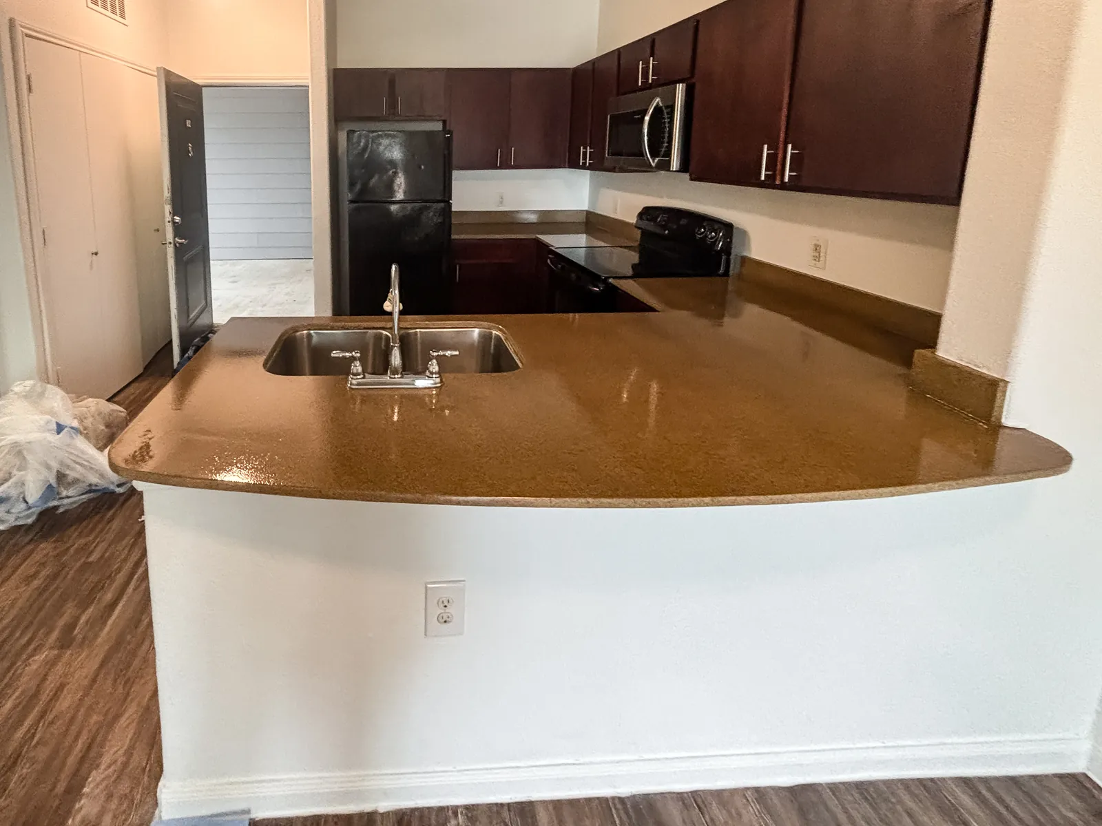 Kitchen countertop refinished in a granite-look fleck, ready for the next tenant