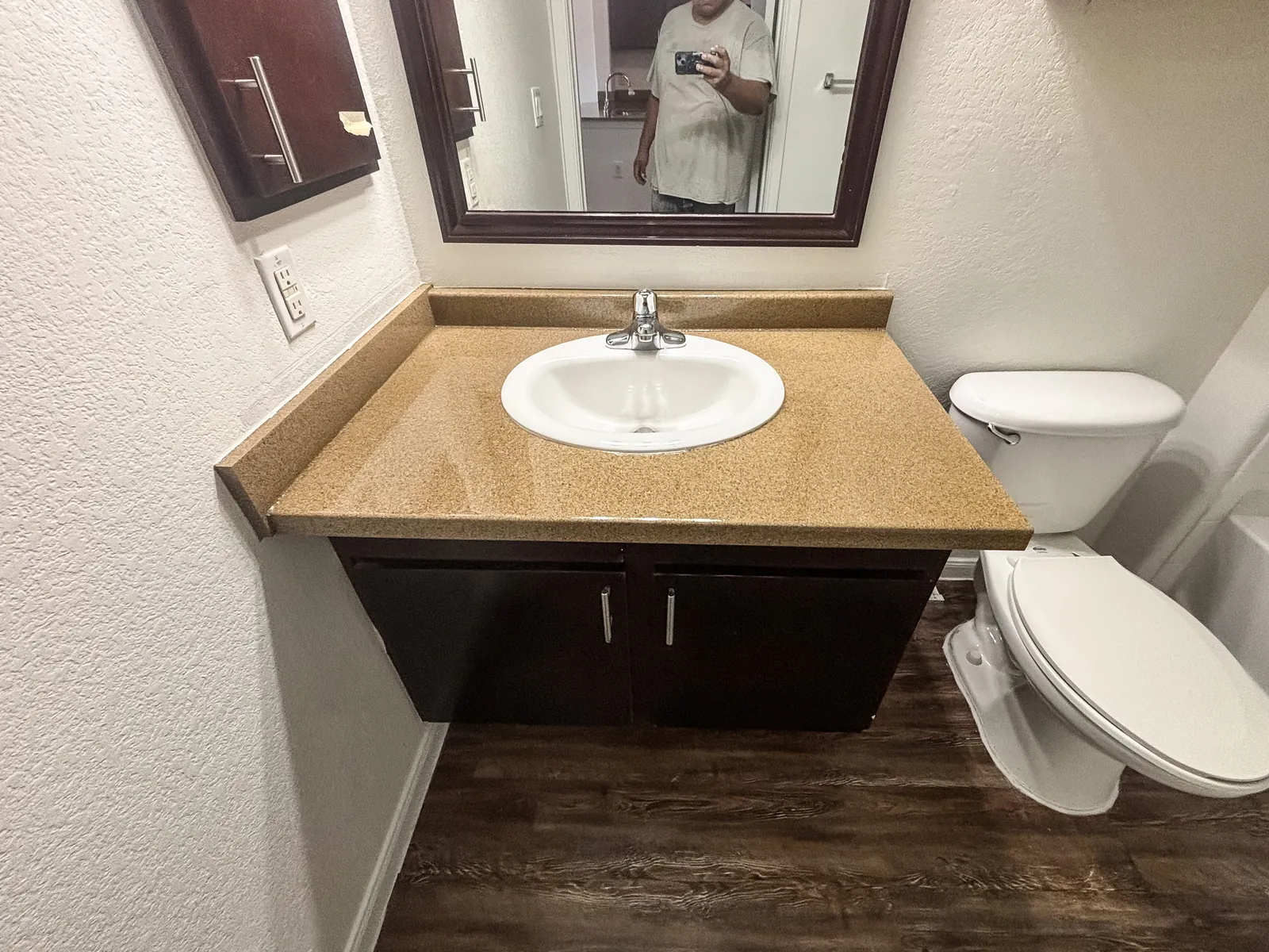 Same vanity top refinished in a tan granite-look fleck, after