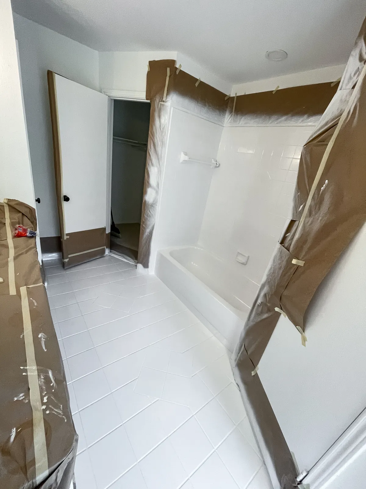 Same bathroom with the tub, tile walls and floor refinished in white, after