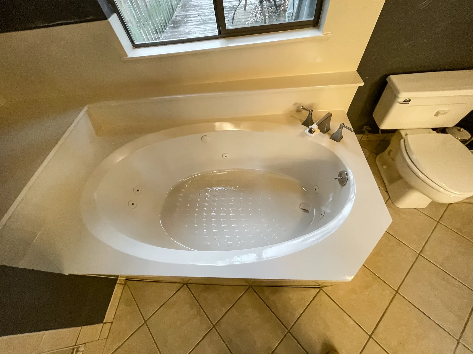 Same tub with the cracks repaired and refinished in white, jets kept