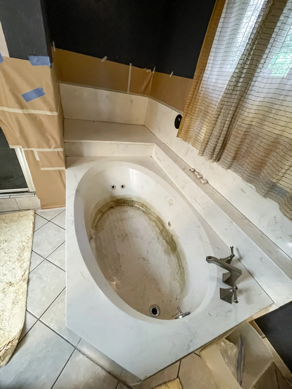 The tub stripped of its old finish, room masked off