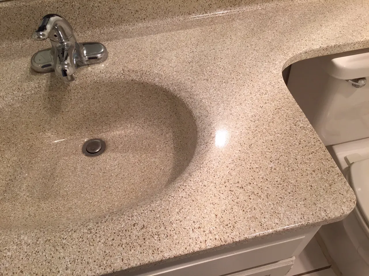 Cultured marble vanity top refinished in a multispec stone finish