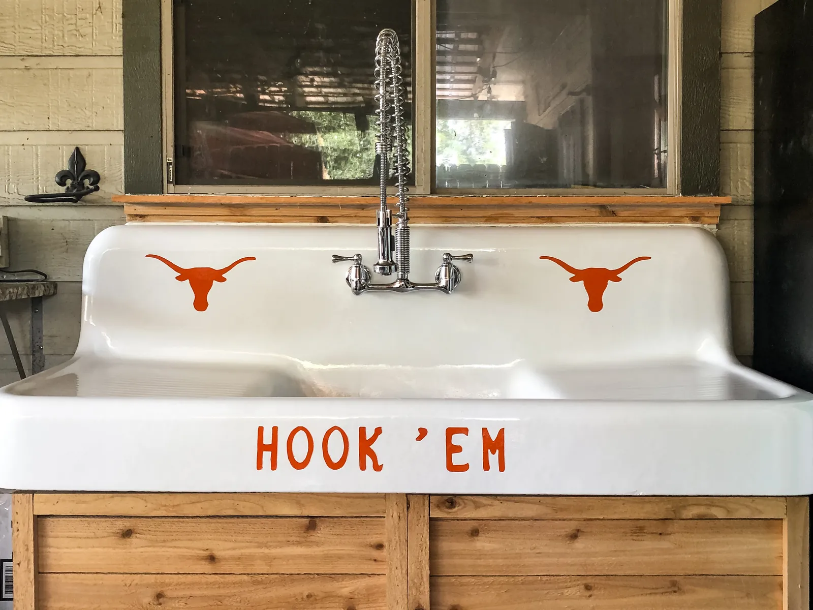 Cast iron farmhouse sink refinished with a custom Longhorn detail