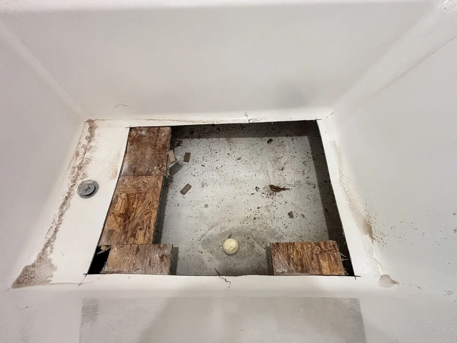 Tub floor cut open to the subfloor