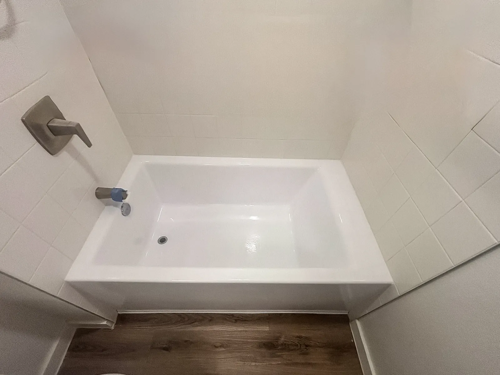 Tub refinished in white with the floor repair invisible