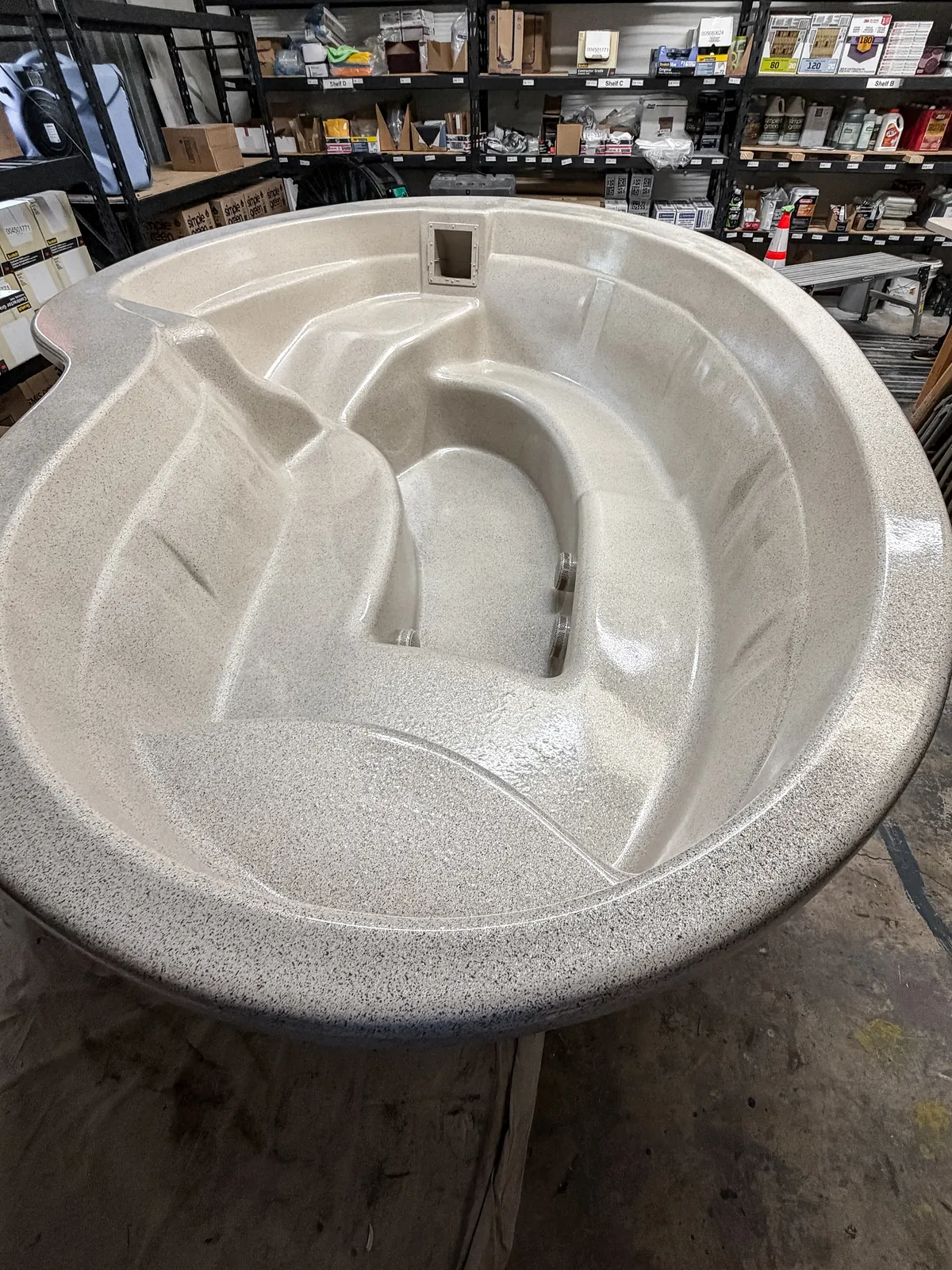 Full-size spa shell repaired and refinished in the Advanced Refinish shop in Austin