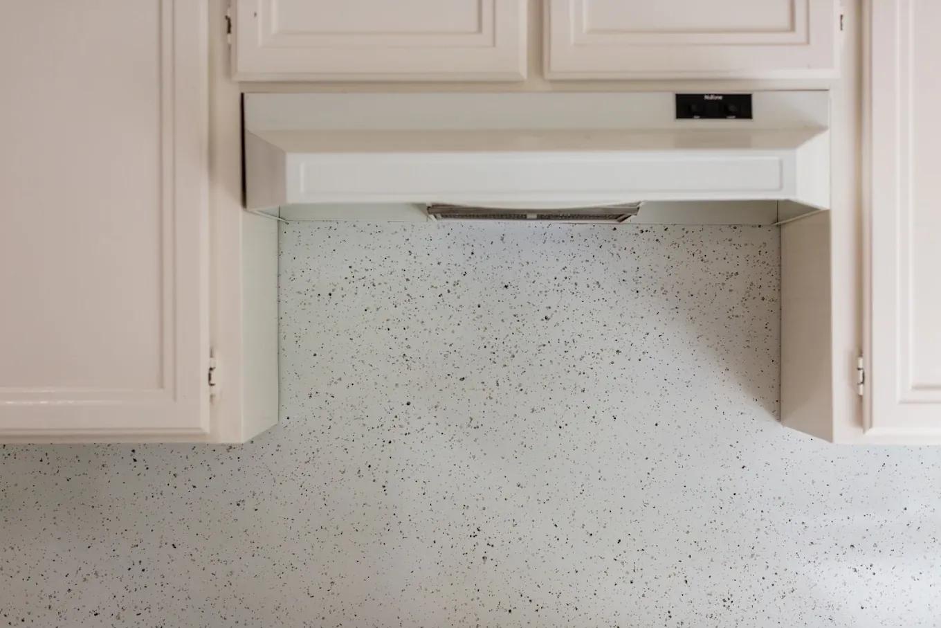 Kitchen tile backsplash refinished in a multispec stone finish