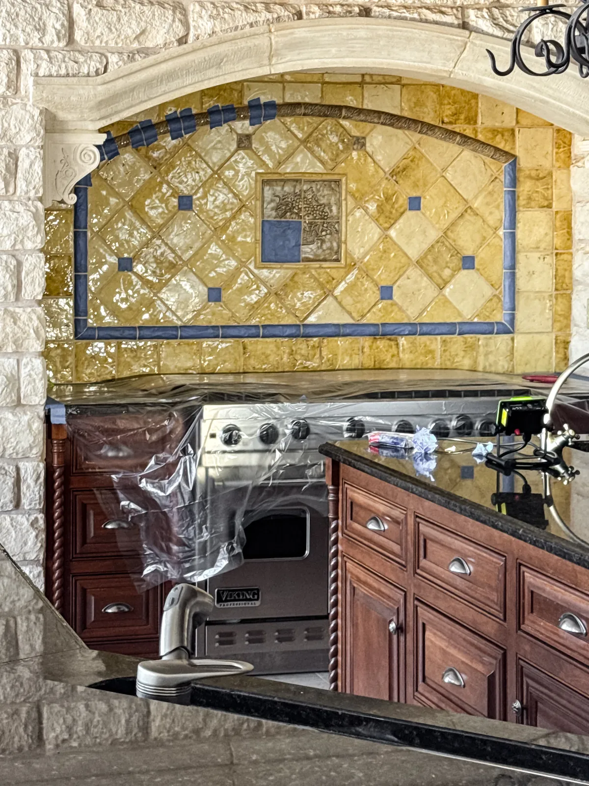 Kitchen tile backsplash masked off before refinishing