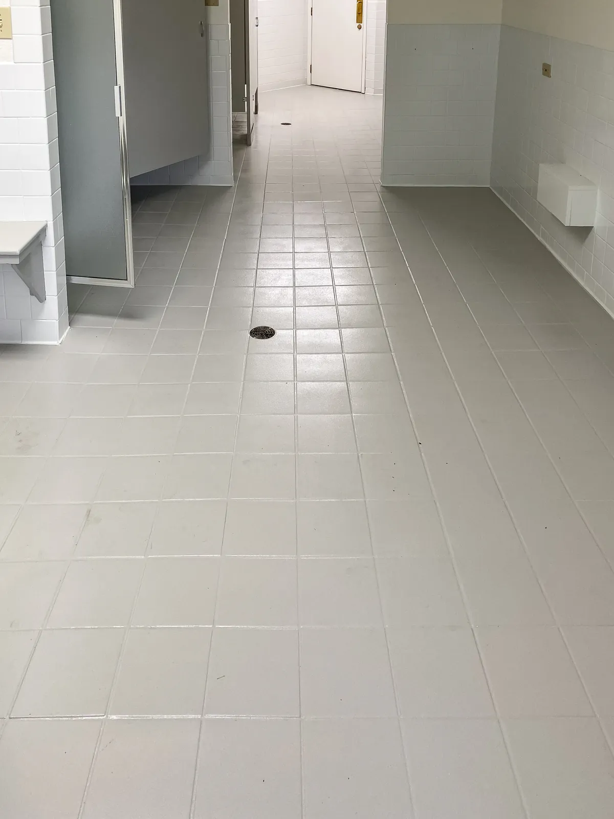 Locker room tile floor refinished in light gray, after