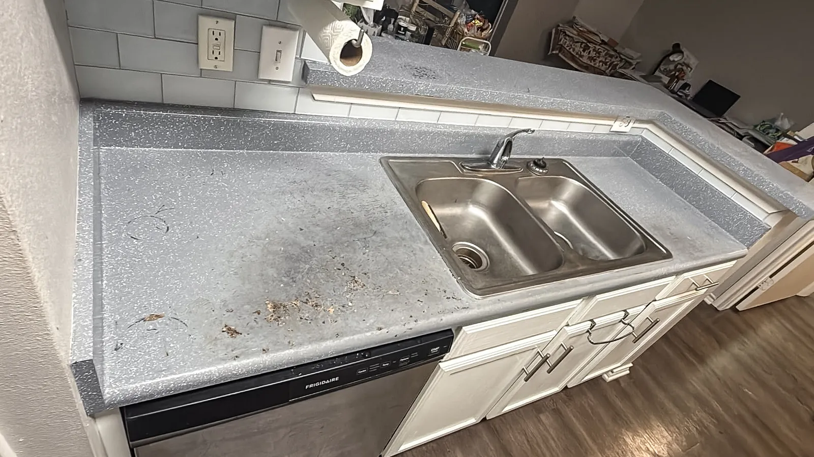 Damaged laminate kitchen counter in an apartment, before