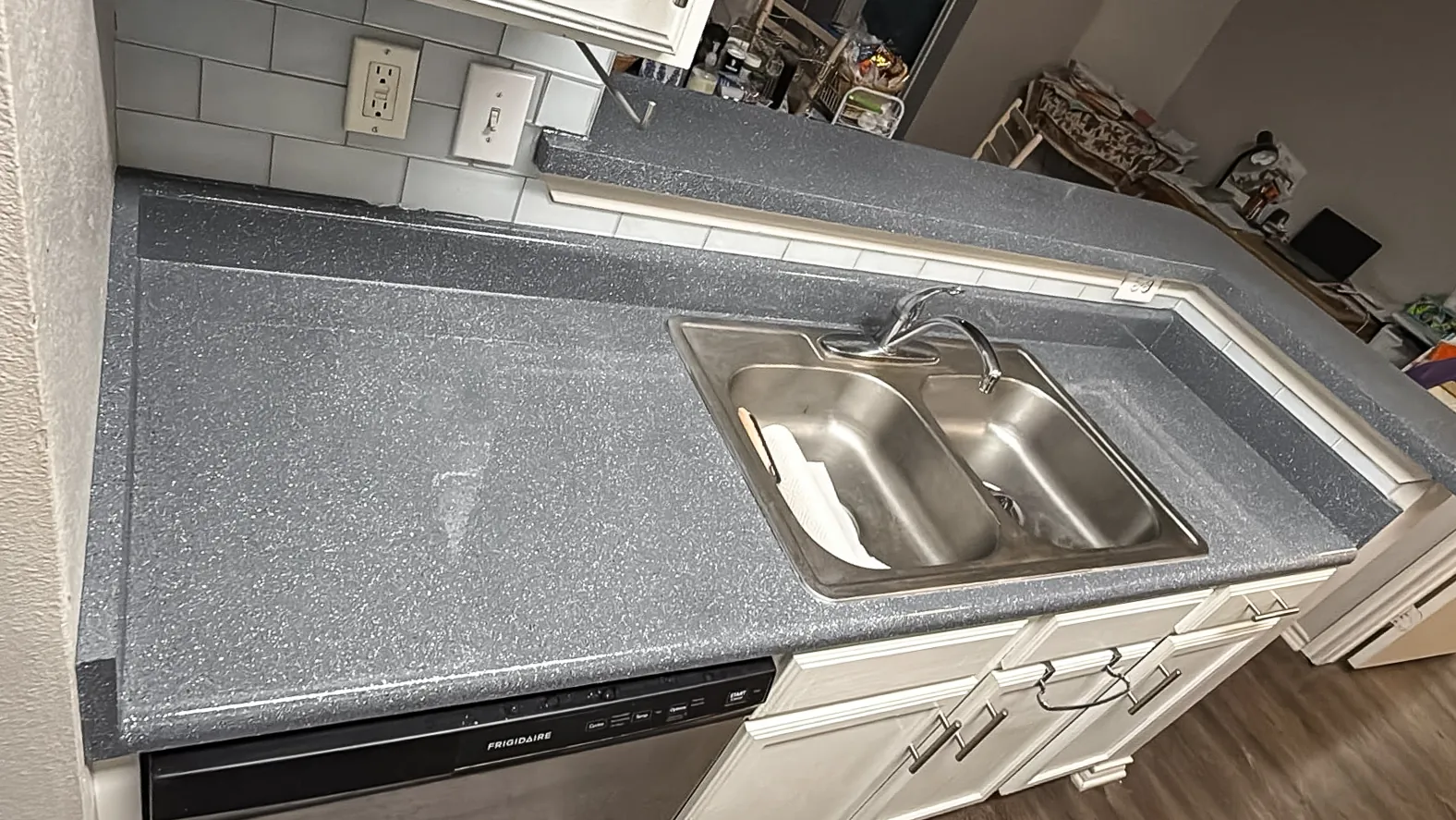 Same counter refinished in a gray granite-look fleck, after