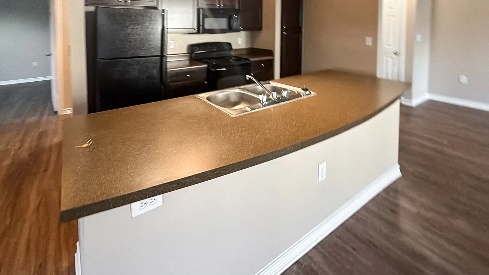 Apartment kitchen island with a worn tan laminate counter, before