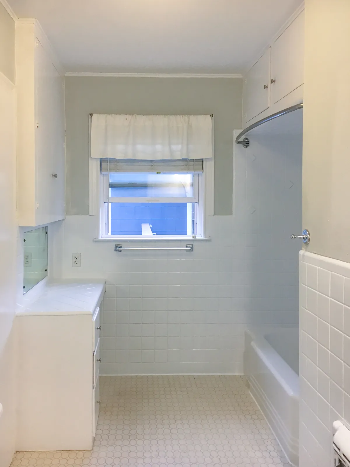 Blue tile bathroom after refinishing in white